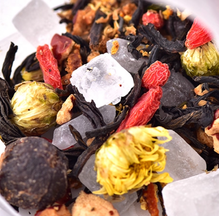 Herbal tea blend with chrysanthemum flowers, goji berries, rock sugar, and loose leaf tea for a floral, sweet, and nourishing brew.